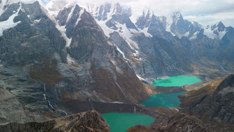 spectacular aerial panorama reveals the iconic tres lagunas - jurau, solteracocha, and azulcocha - amidst the majestic cordillera huayhuash peaks in peru
