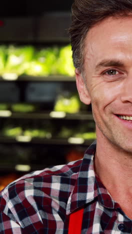 portrait of smiling male staff standing with arms crossed in organic section