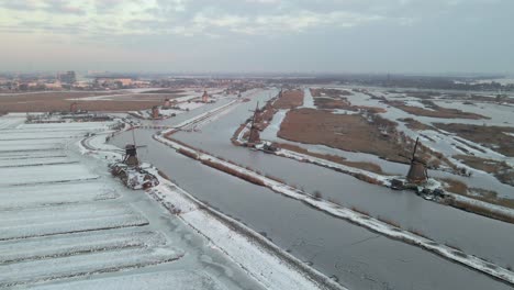 Traditional-flat-land-of-Netherlands-with-famous-wooden-windmills-in-winter