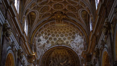 Inside-of-a-Roman-Church-with-Yellow-Lights-and-some-Natural-Light-entering-from-Above