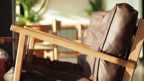 wooden armchair with brown leather padding