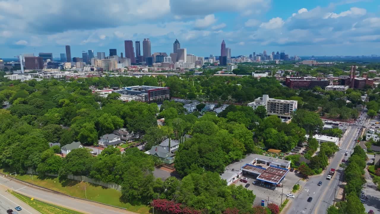 Atlanta city skyline of Atlanta with skyscrapers. Cars on street in idyllic suburbia of USA. Aerial wide shot. Georgia, United States