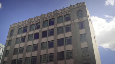 view of a large historic building with many windows against a blue sky