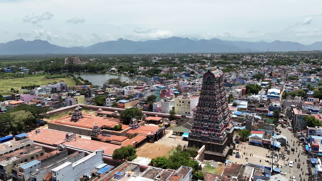 Scenic aerial video of the famous Tenkasi Kasi Viswanathar Temple surrounded by dense urban streets, ancient architecture, and natural landscapes in Tamil Nadu