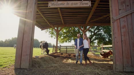 couple feeding animals on a farm