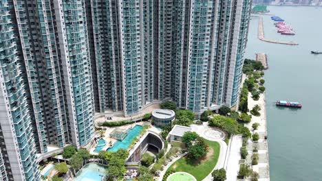 Mega-residential-luxury-buildings-in-downtown-Hong-Kong,-Tilt-up-Aerial-view