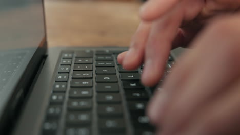 person typing on a laptop keyboard