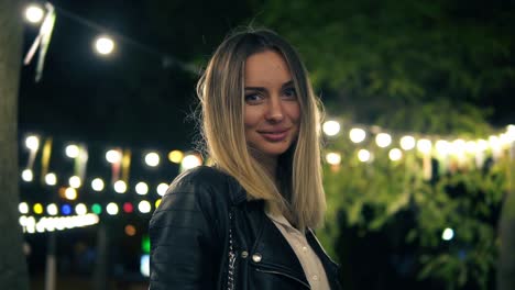 Portrait-Of-A-Beautiful-Girl-In-A-Black-Leather-Jacket-Standing-In-The-Night-Park