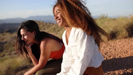 two happy friends enjoying conversation outdoors in a natural landscape