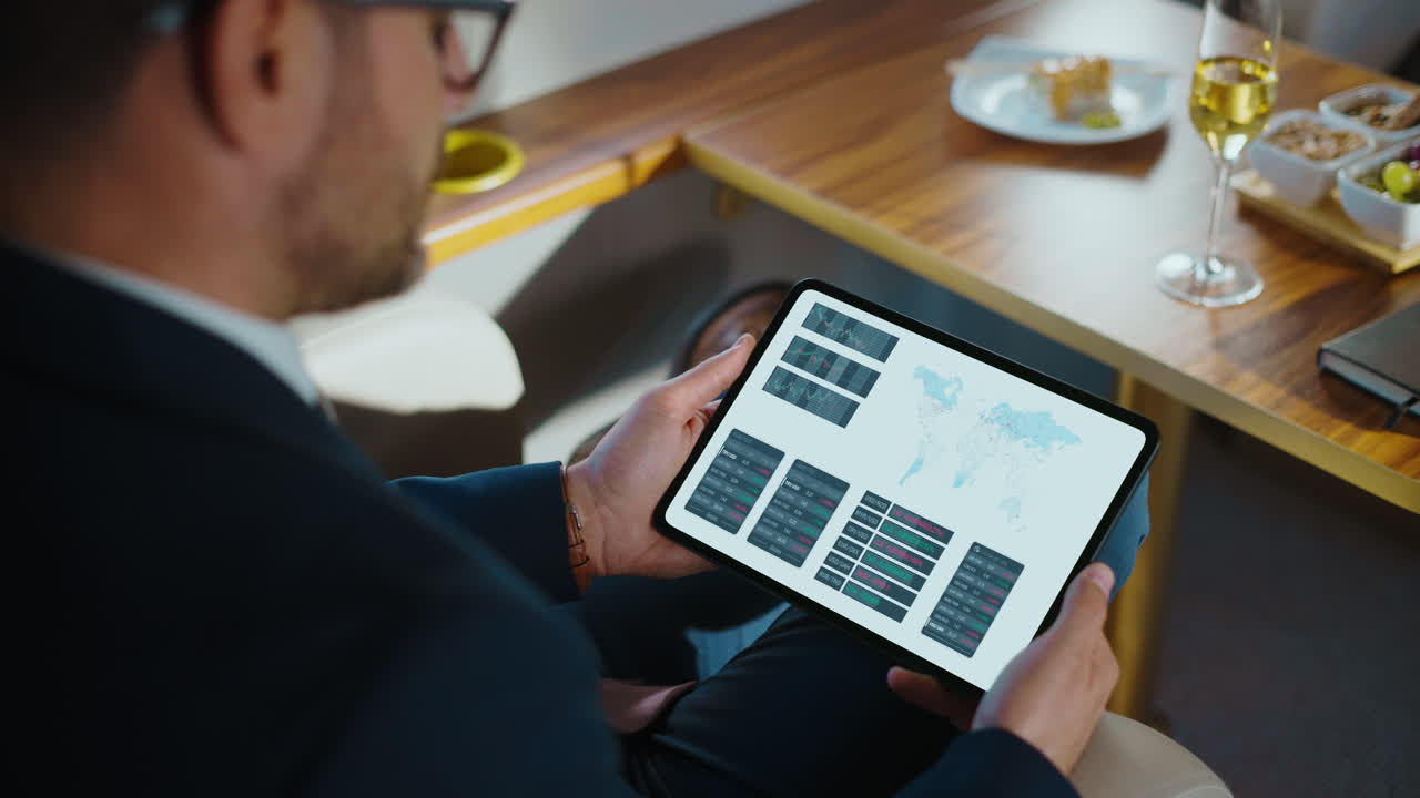 Man analyzes business data on tablet while relaxing