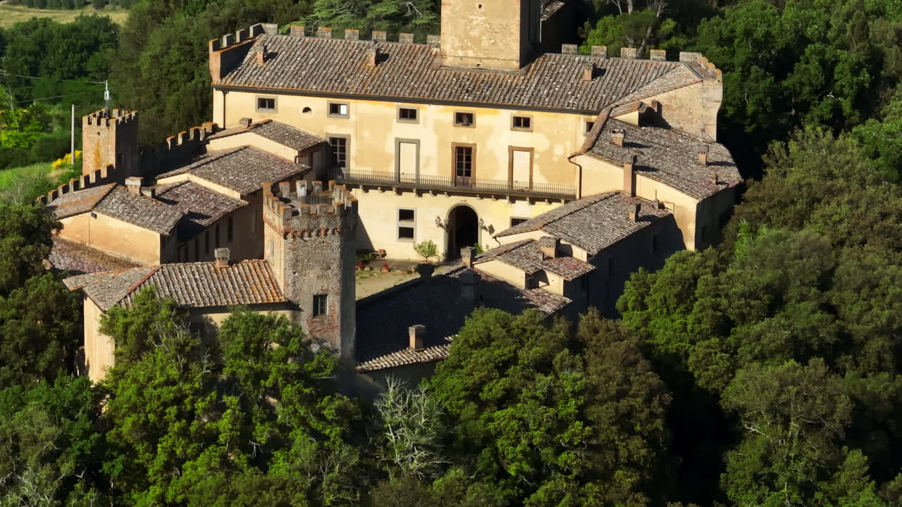 Aerial telezoom backwards over a medieval castle in Chianti, Tuscany, Italy