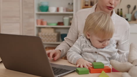 child playing while parent using laptop