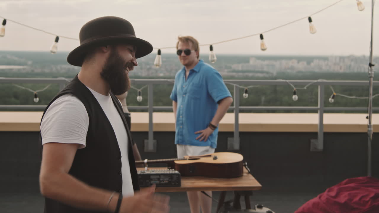 Friends Greeting Each Other at Party on Rooftop