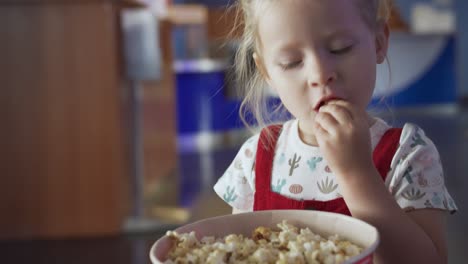 little girl eating popcorn