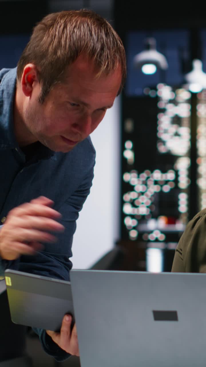 Vertical Video Multiethnic budgeting team reviewing numbers and sales on computer