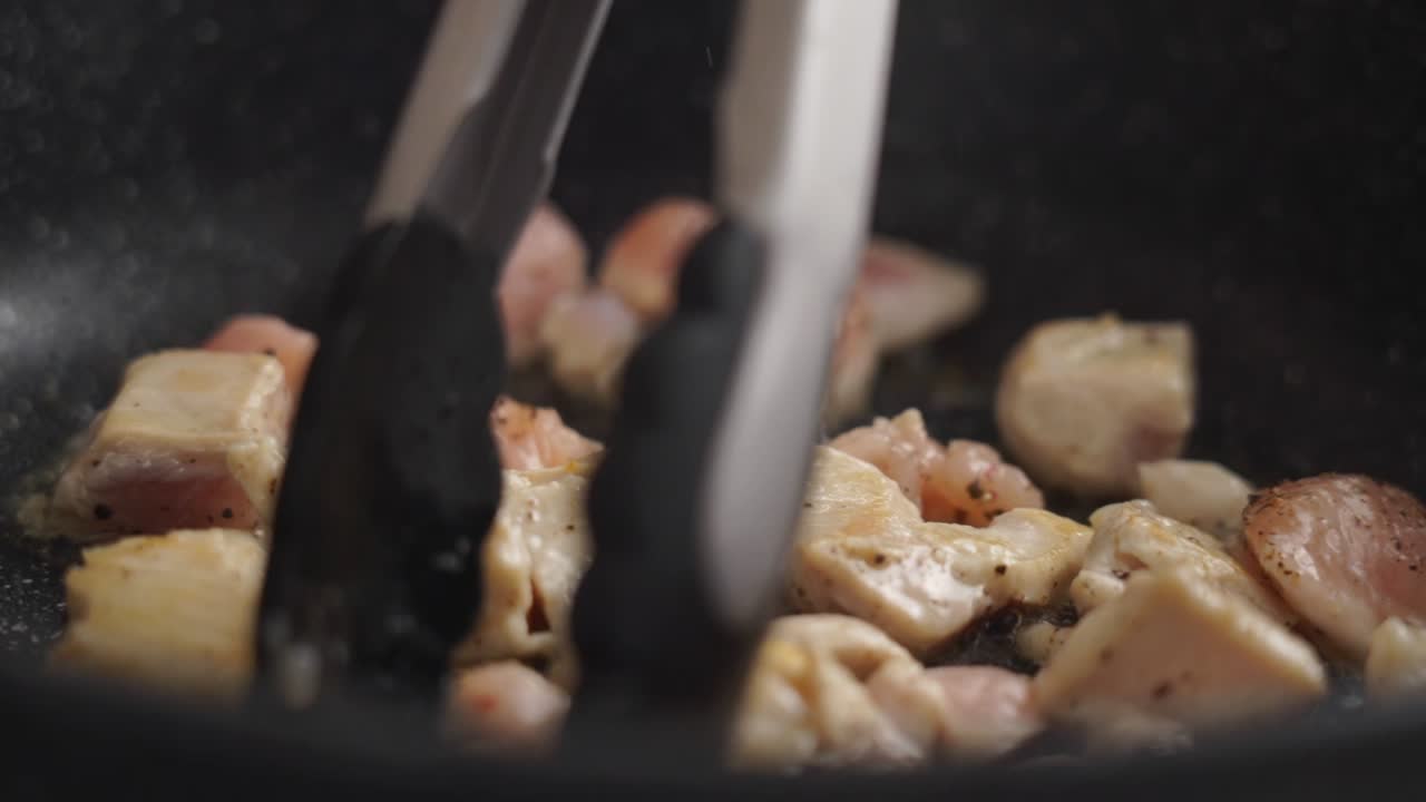 cocinero irreconocible fritando pechuga de pollo picada en sartén