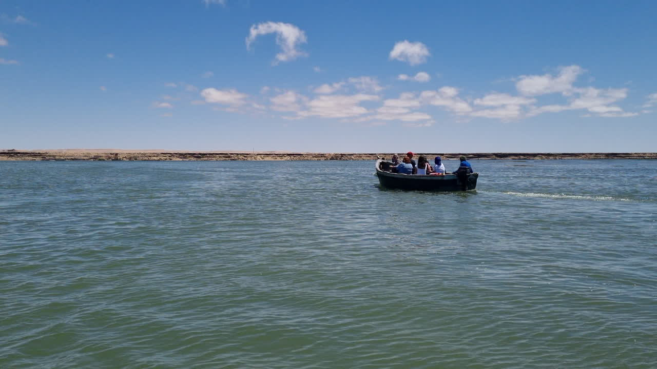 grupo de turistas en movimiento en barcos de pescadores en la laguna de nayla en marruecos
