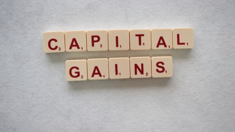 human hands creating the phrase "capital gains taxes