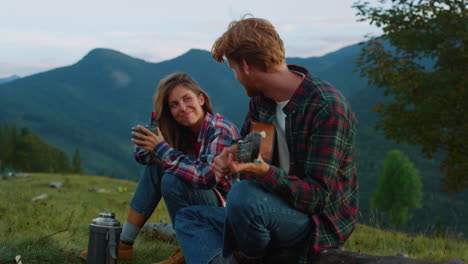 smiling couple camp mountains on vacation holiday. two lovers flirt on nature.