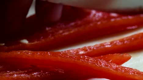 extreme closeup of a red pepper being chopped