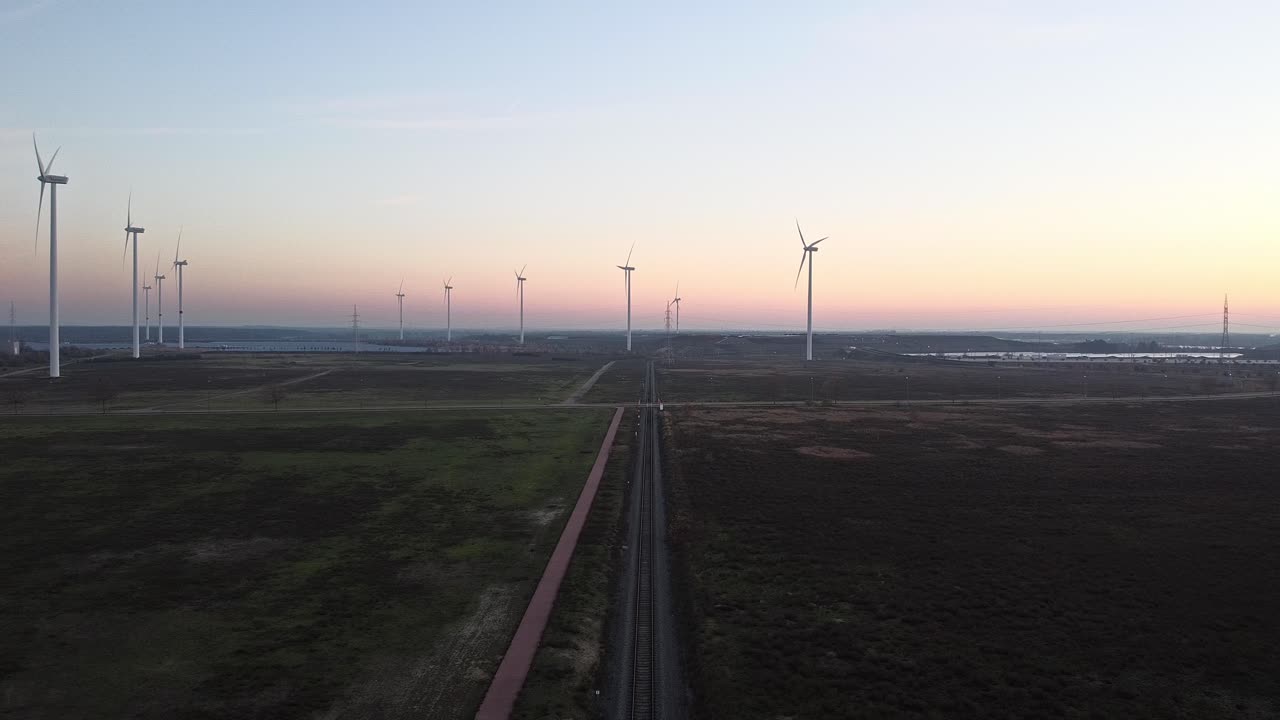 Aerial View of Wind Farm at Sunset with Railroad Tracks