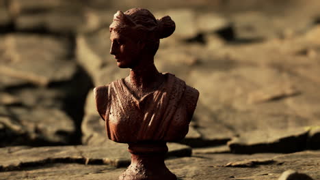 ancient-statue-of-woman-on-rocky-stones