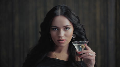 woman holding a martini cocktail