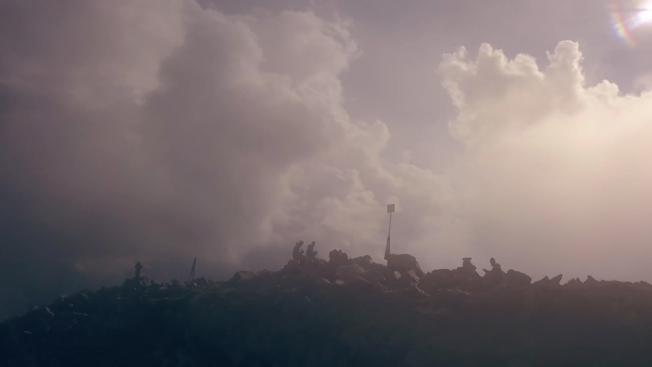 A group of friends sitting at the top of Peleaga Summit.