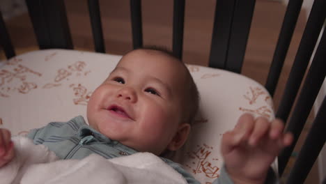 Adorable-baby-laughing-and-smiling-in-crib