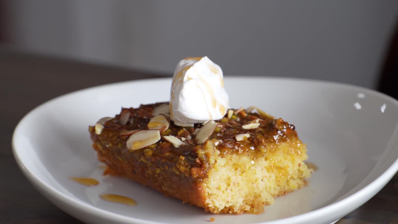 Eating A Slice Of Banana Caramel Cake Topped With Icing. closeup