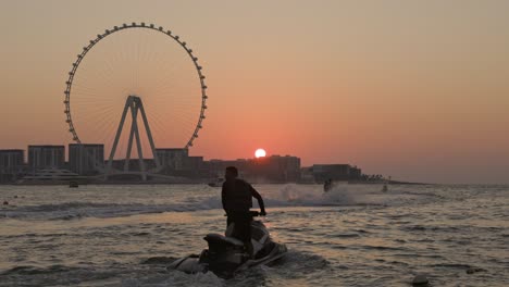 unsurpassed sunset over the biggest ferris wheel in dubai marina uae.