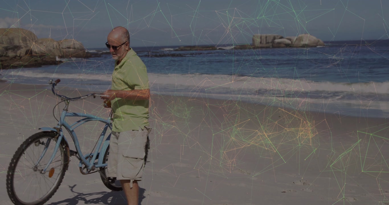 Senior man starting walk on beach, pushing blue bicycle for leisure with net overlay tracking him