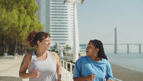 front view of fat happy women running in park on summer day