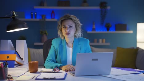 home office worker woman looking dull at camera.