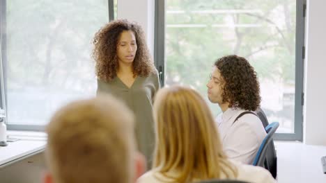 manager scolding her employees in the office of a coworking