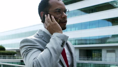 focused businessman talking by smartphone