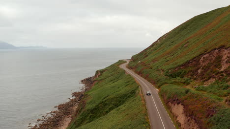Amazing-panoramic-route-above-cliffs-along-Slea-Head-coast.-Forwards-tracking-of-car-on-road-traversing-slope.-Ireland