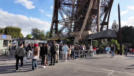 long queue of tourists at the eiffel tower entrance in paris