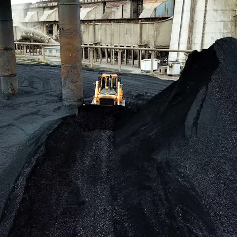 crawler bulldozer sorts coal. industry. aerial view.