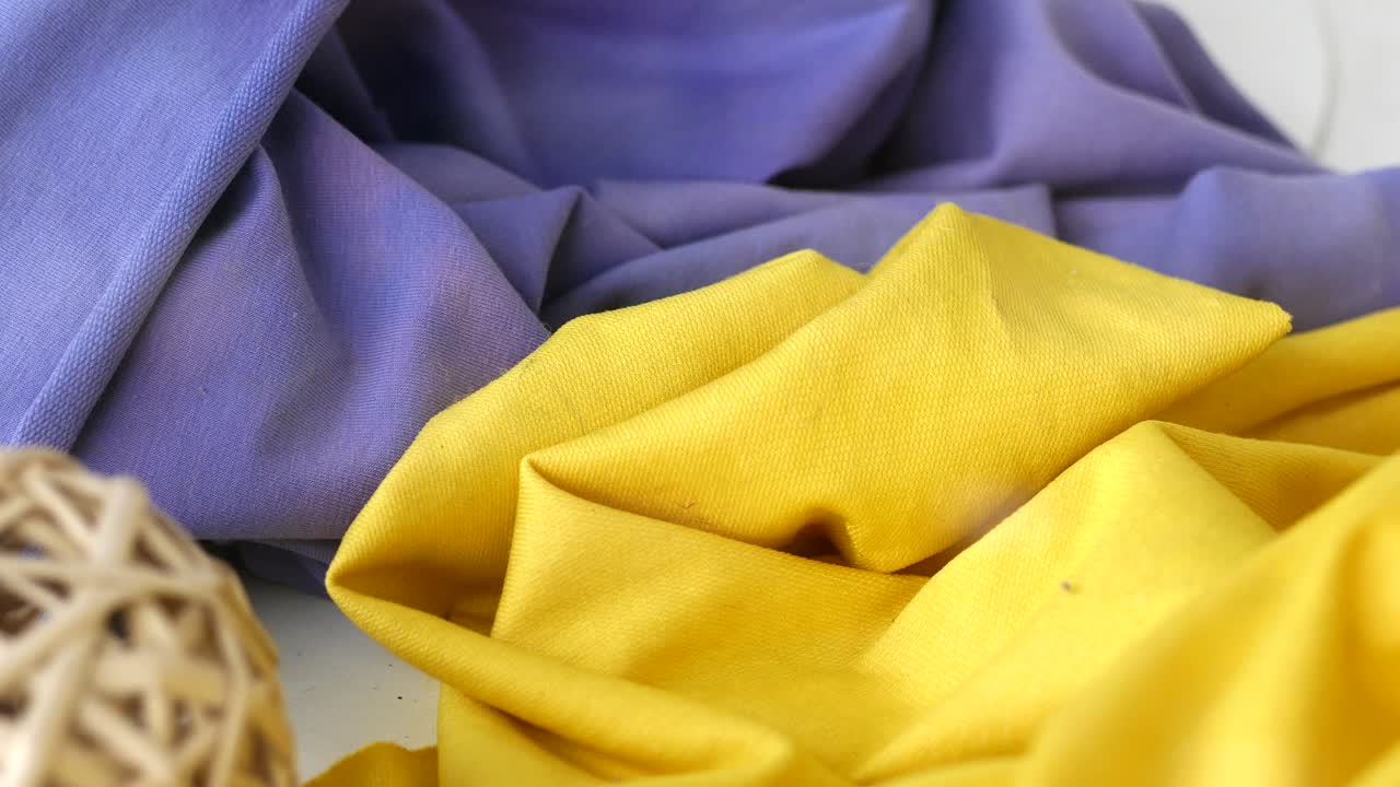 Close-up view of folded yellow and blue fabric