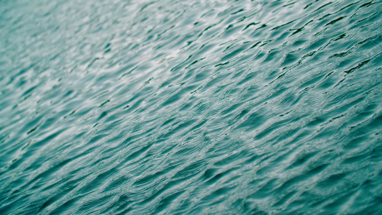Close-up view of ripples and sun glare on the freshwater lake