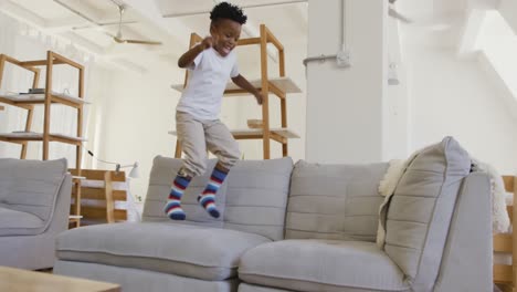 young boy bouncing on couch