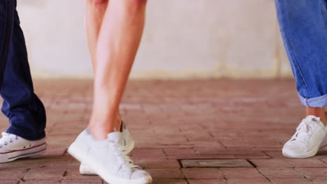 people walking/dancing on a brick floor