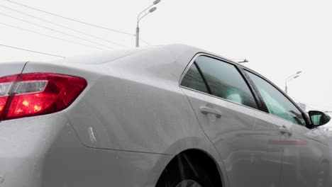 businessman opening car door on a rainy day