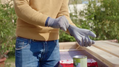 the craftsman putting on his protection gloves