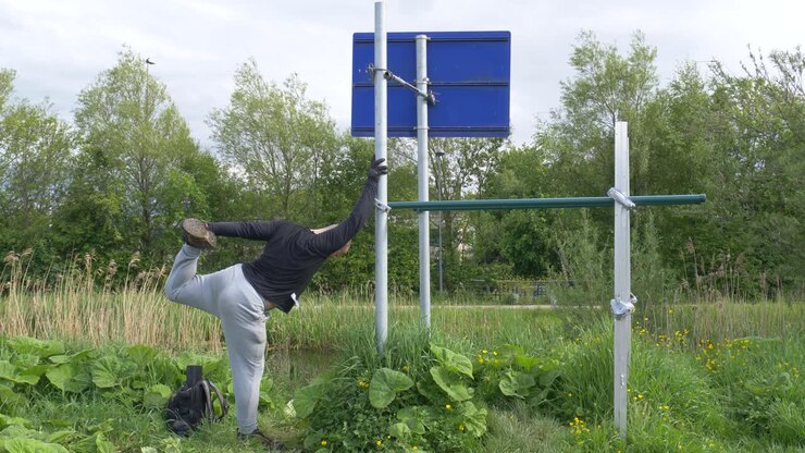 Muscular Man Doing Pull-ups On DIY Horizontal Bar - Training Of Strong Man Outdoor In The Morning - wide shot