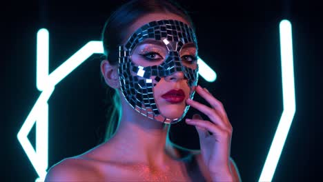 a captivating image of a model wearing a striking mirror mask, illuminated by vibrant neon lights, showcasing an enchanting blend of beauty and intrigue