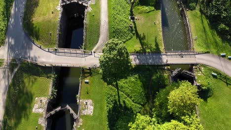 top down aerial above historic gamle dal sluice with green nature in sweden