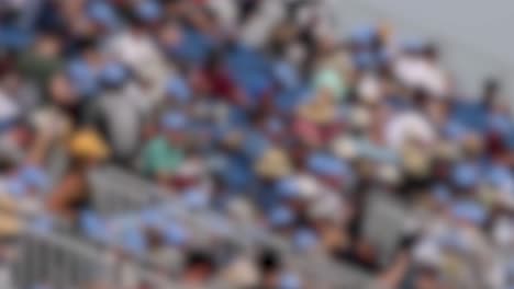 blurred video frames capture a lively stadium crowd in geelong, australia, highlighting dynamic movement and vibrant colors