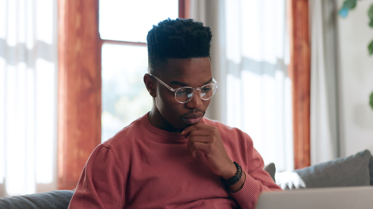 Man, glasses and thinking for typing in living